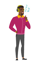 Image showing Businessman listening to music in headphones.