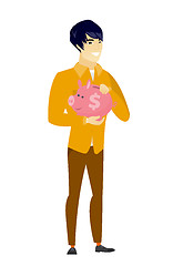 Image showing Asian business man holding a piggy bank.