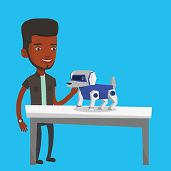 Image showing Happy young man playing with robotic dog.