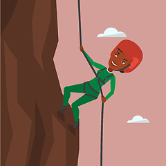 Image showing Woman climbing in mountains with rope.