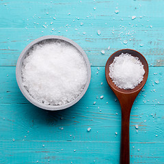 Image showing sea salt in bowl and in spoon on wooden background