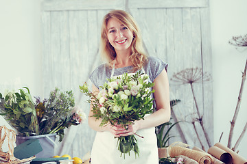 Image showing Florists woman working at greenhouse.