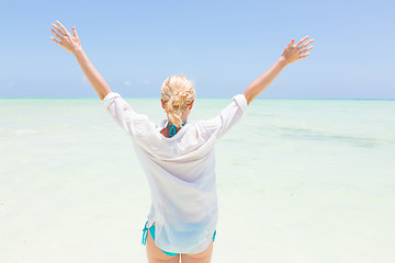 Image showing Happy woman enjoying, relaxing joyfully in summer on tropical beach.