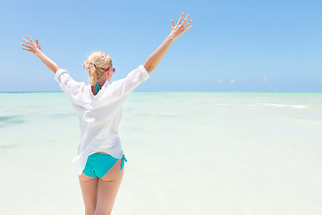 Image showing Happy woman enjoying, relaxing joyfully in summer on tropical beach.