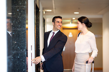 Image showing business team with travel bags at hotel elevator