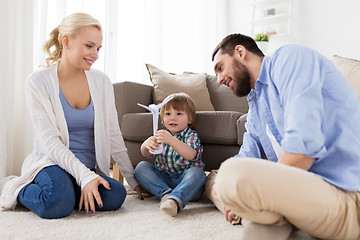 Image showing happy family playing with toy wind turbine