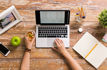 Image showing hands with receipt on laptop screen at office