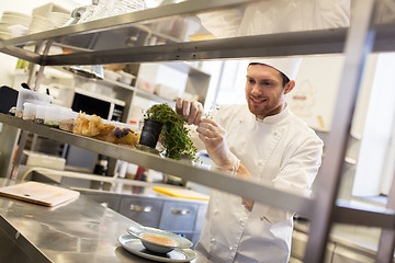 Image showing happy male chef cooking at restaurant kitchen