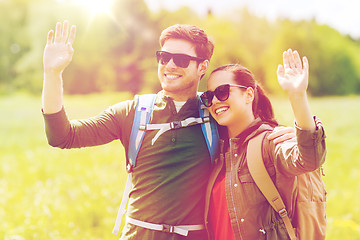 Image showing happy couple with backpacks hiking outdoors