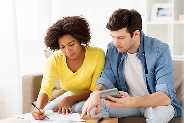 Image showing couple with papers and calculator at home