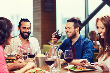 Image showing friends dining and drinking wine at restaurant