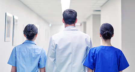 Image showing group of medics or doctors walking along hospital