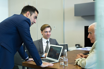 Image showing Business people sitting and brainstorming at corporate meeting.