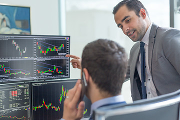 Image showing Stock brokers looking at computer screens, trading online.