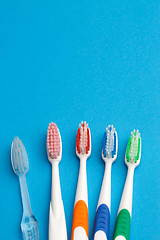 Image showing Photo of five multi-colored toothbrush