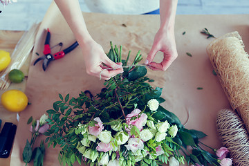 Image showing Florist makes composition of flowers