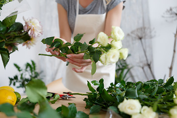 Image showing Young florist woman with flowers