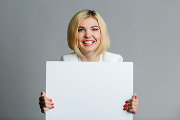 Image showing Young woman with blank sheet