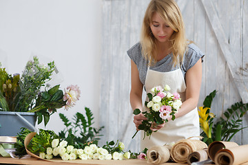 Image showing Photo of girl making bouquet