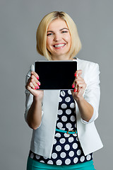 Image showing Smiling young blonde holding tablet