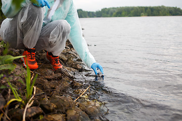 Image showing Photos chemist takes water samples