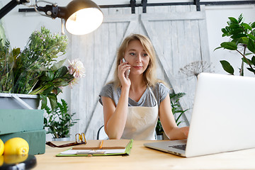 Image showing Woman florist talking on phone