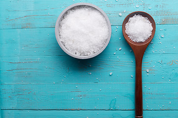 Image showing sea salt in bowl and in spoon on wooden background