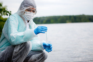 Image showing Chemist takes water for examination