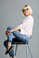 Image showing Girl in glasses on chair