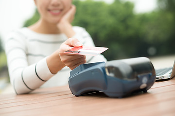 Image showing Woman pay by mobile phone on pos machine