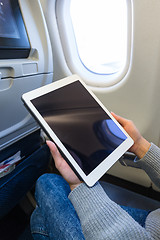 Image showing Woman use of tablet pc inside aircraft