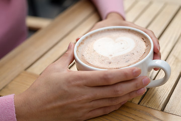 Image showing Woman having coffee at outdoor cafe