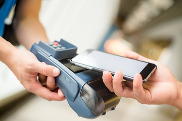 Image showing Customer using cellphone for pay by NFC technology