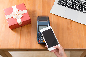 Image showing Pay with cellphone on POS machine for buying gift