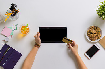 Image showing hands with tablet pc and credit card at table