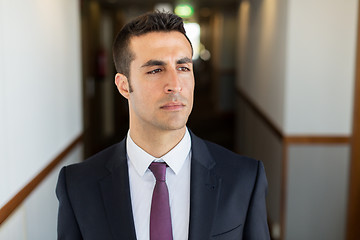 Image showing businessman in suit at hotel corridor 