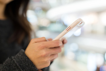 Image showing Woman using mobile phone in shopping mall