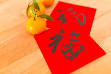 Image showing Chinese New Year Calligraphy with tangerine, words meaning lucky