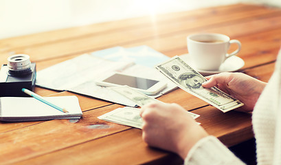 Image showing close up of traveler hands counting dollar money