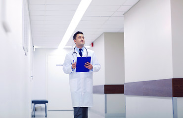 Image showing doctor with clipboard walking along hospital