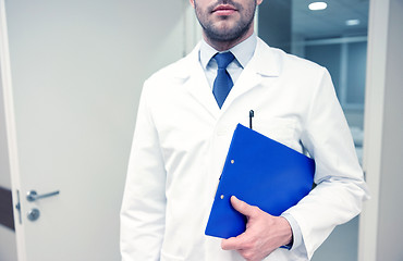 Image showing close up of doctor with clipboard at hospital