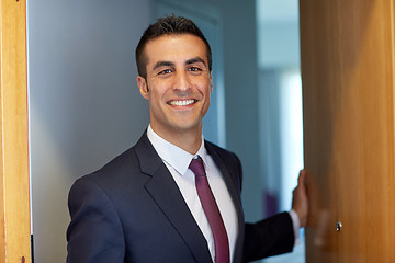 Image showing businessman at hotel room or office door