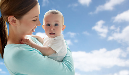 Image showing happy young mother with little baby over blue sky