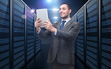 Image showing businessman with tablet pc over server room