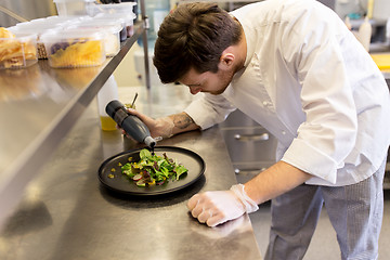 Image showing male chef cooking food at restaurant kitchen