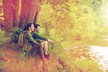 Image showing smiling couple with backpacks in nature