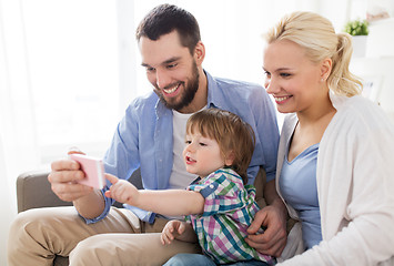 Image showing happy family with smartphone at home