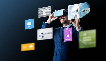 Image showing businessman in virtual reality headset over black