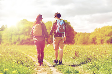 Image showing happy couple with backpacks hiking outdoors