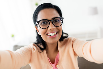 Image showing happy smiling woman taking selfie at home